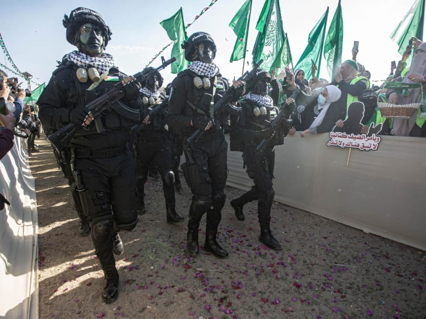Armed elements of the Izz al-Din al-Qassam Brigades called the "Chorus Unit", the military wing of the Palestinian Hamas movement, participate in the thirty-fifth anniversary of the founding of Hamas in Gaza City.