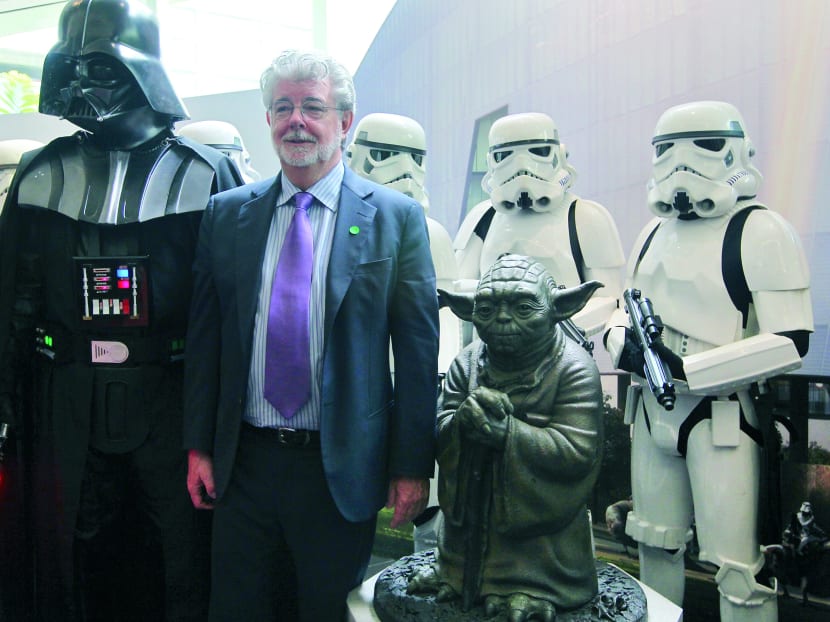 George Lucas photographed with characters from Star Wars at the official launch of Lucasfilm's building dubbd The Sandcrawler in Singapore in 2014. TODAY file photo