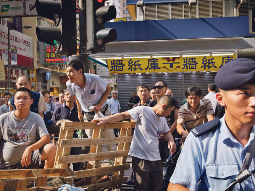A man yelling at pro-democracy protesters gathered at a barricade in the Mong Kok area of Hong Kong yesterday. The New York Times