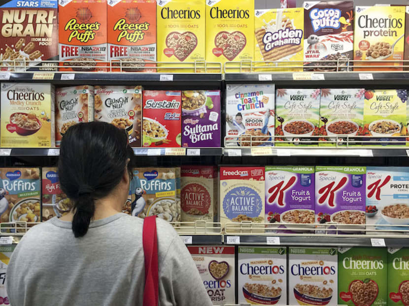 A shopper looking at cereal brands available at a supermarket in Kuala Lumpur. Of the 10 popular breakfast cereal brands that are targeted at young consumers in Malaysia, only one qualified as low in sugar. Photo: Malay Mail Online