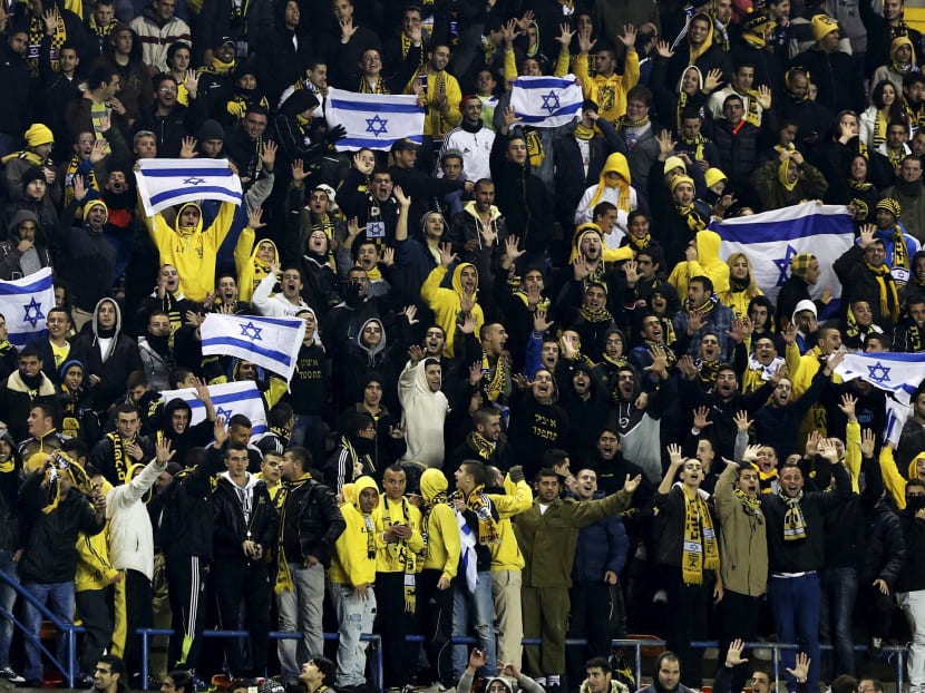 Supporters of Beitar Jerusalem cheer their team during a soccer match against Maccabi Umm el-Fahm at Teddy Stadium in Jerusalem. Reuters file photo