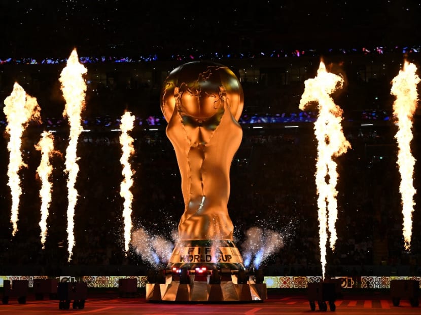 Fireworks explode around a replica of the Fifa World Cup trophy during the opening ceremony ahead of the Qatar 2022 World Cup Group A football match between Qatar and Ecuador at the Al-Bayt Stadium in Al Khor, north of Doha on Nov 20, 2022.
