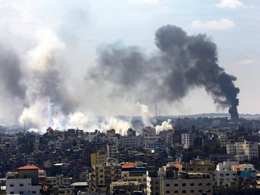 Smoke from Israeli strikes rising over Gaza City yesterday. Hamas militants are looking for ways to replenish its missile stock so that they can maintain their offensive against Israel. Photo: AP