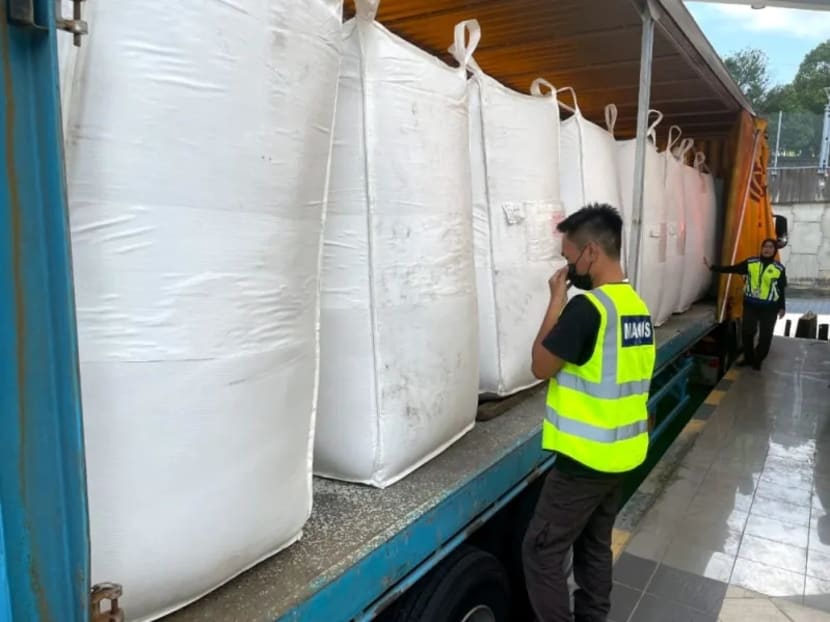 In this image, courtesy of Malaysian Quarantine and Inspection Service Department (Maqis), a Maqis enforcement officer inspects the jumbo bags containing rice at the Bangunan Sultan Iskandar (BSI) cargo import area, June 28, 2023.
