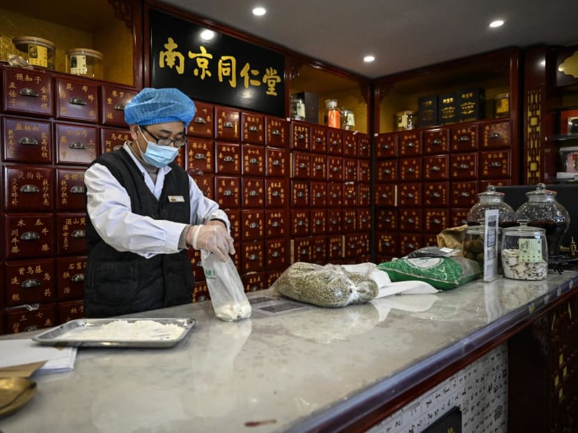 An employee working at a traditional Chinese medicine pharmacy in Beijing. 