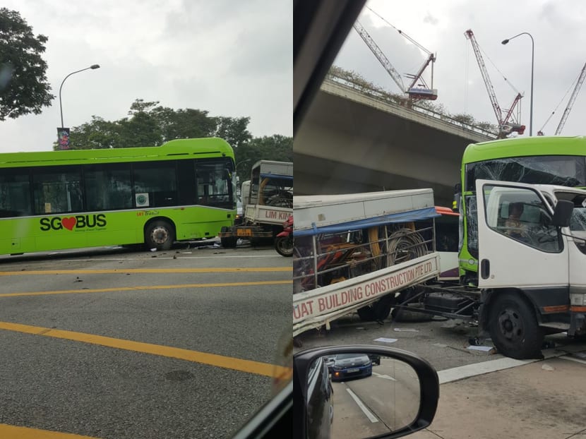 In videos circulating on social media, a green SBS Transit bus is seen crashing into a lorry bearing the company name Lim Kim Huat Building Construction. The force drives both vehicles across the junction and the lorry hits a car that has stopped for the red light.