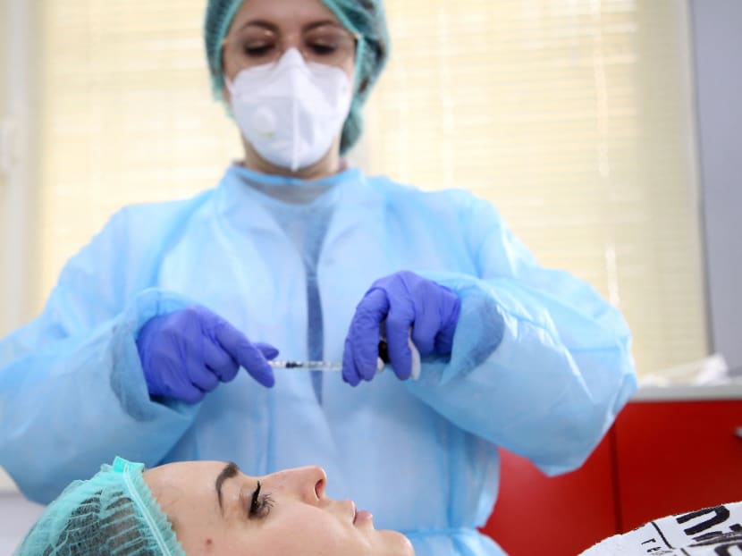 Dermatologist Brunilda Bardhi applies aesthetic treatment to a woman at a clinic in Tirana on February 4, 2021.