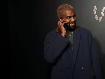 Rapper Kanye West talks on the phone before attending the Versace presentation in New York, United States on Dec 2, 2018.