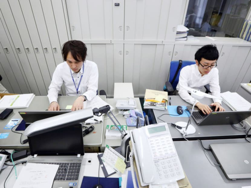 Japan’s working culture is very male-centred, with salarymen under irresistible pressure to match the long hours clocked by their colleagues. This will have to change before female participation in the workforce can increase. Photo: Bloomberg