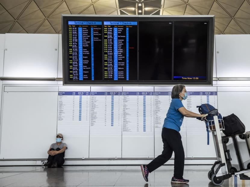 An electronic sign displays flight schedules at Hong Kong International Airport on Sept 23, 2022. 