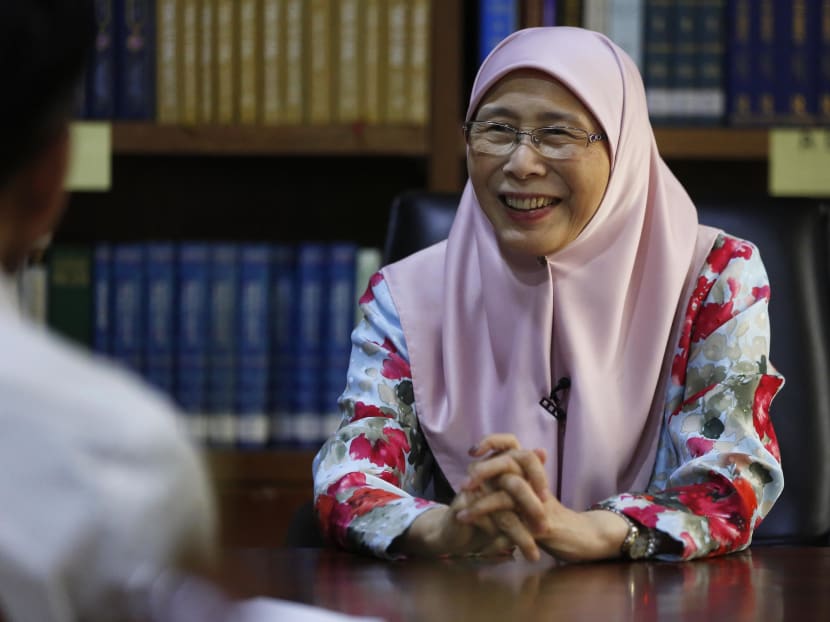 Dressed in a pink headscarf and traditional baju kurung with a floral print, Dr Wan Azizah holds court in her library, which is filled with a vast collection of titles.