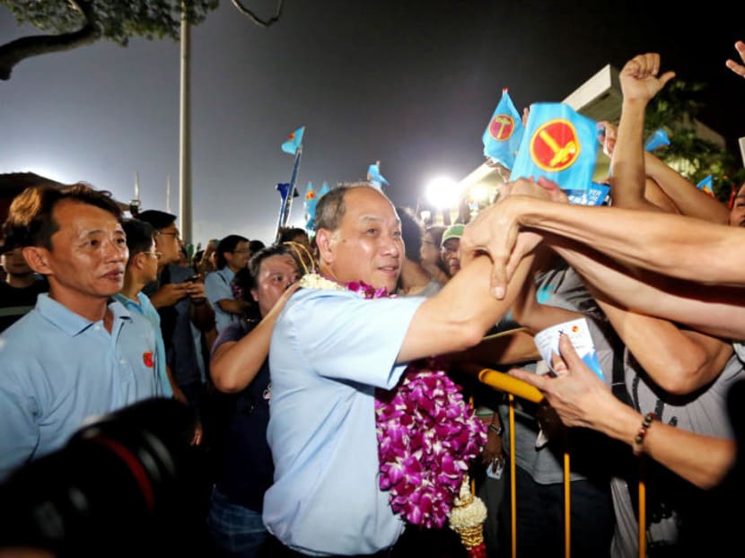 Mr Low Thia Khiang shaking hands with residents at the end of the Workers' Party rally at Bedok Stadium on Sept 9, 2015.