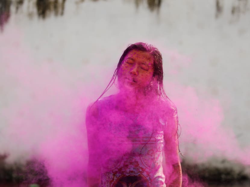 A student is covered in coloured powder while celebrating Holi, the Festival of Colours, at a college in Kathmandu, Nepal, March 19, 2019.