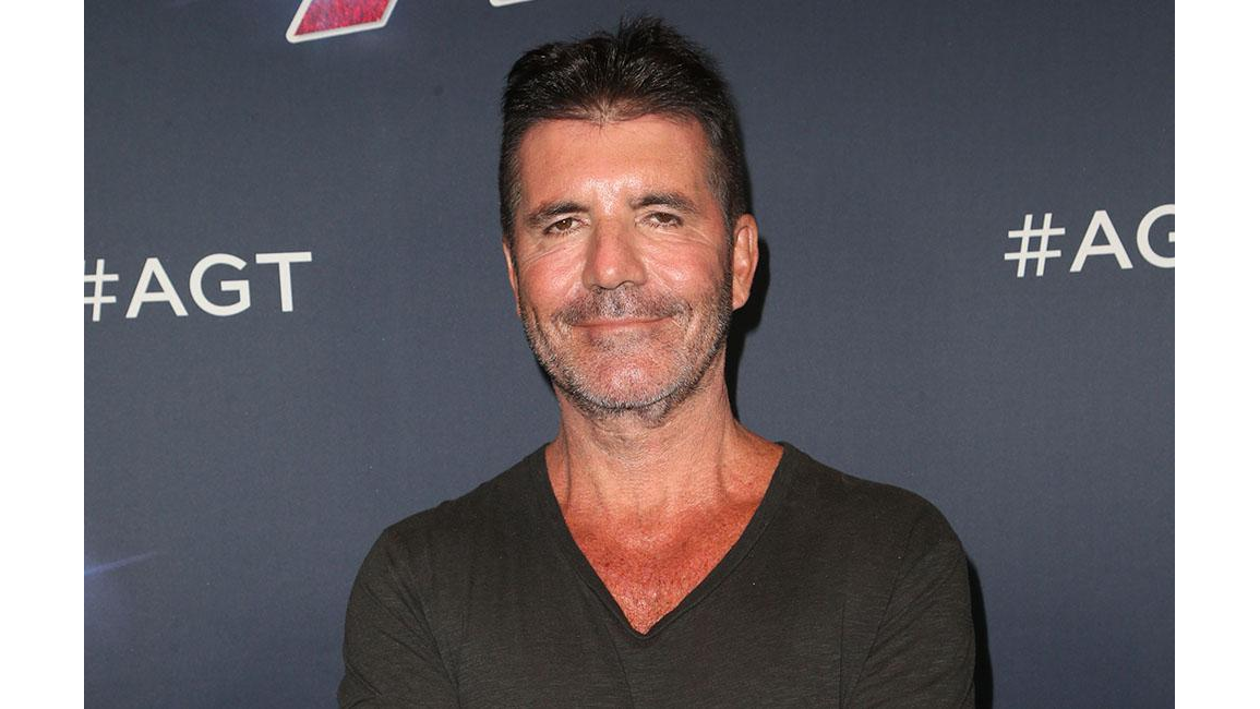 Simon Cowell happy for Kelly Clarkson 8days