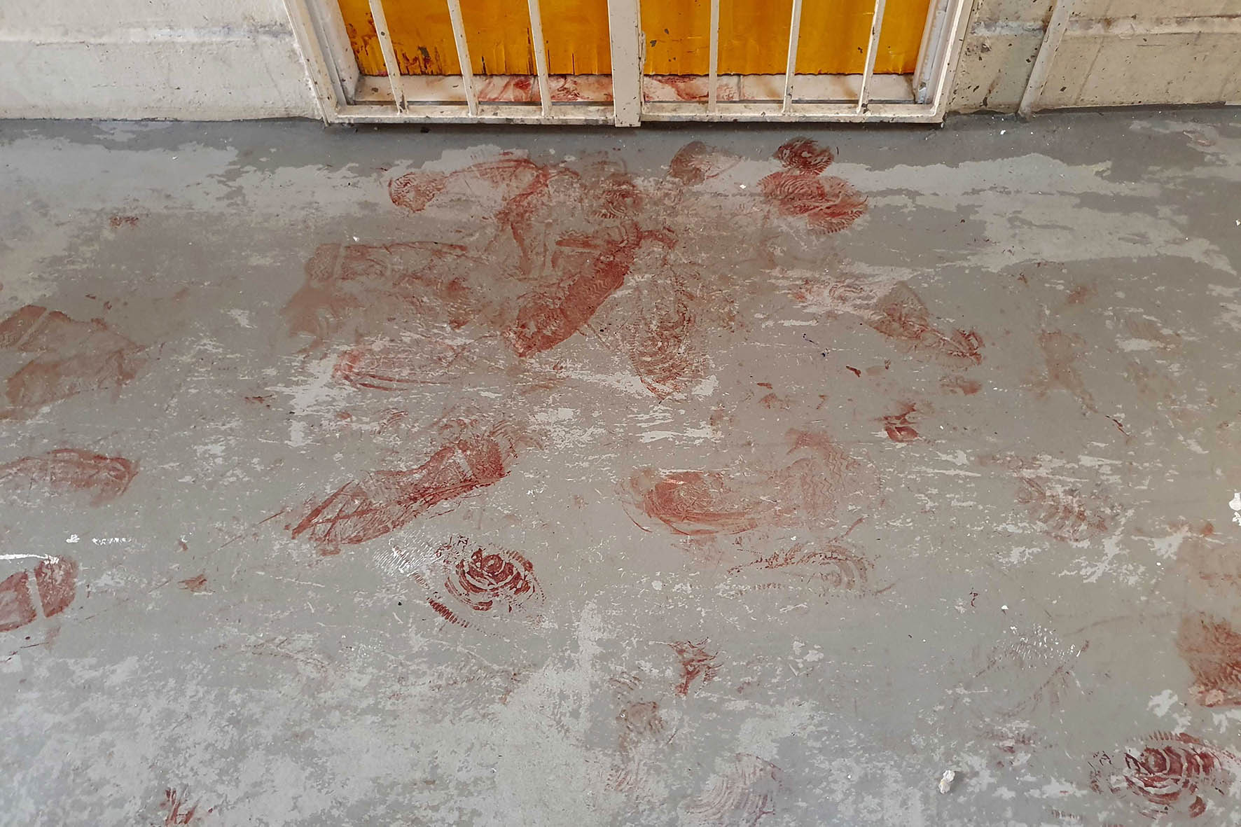 Bloody shoe prints seen outside the unit where the murder happened. Photo Taufiq Zalizan/TODAY