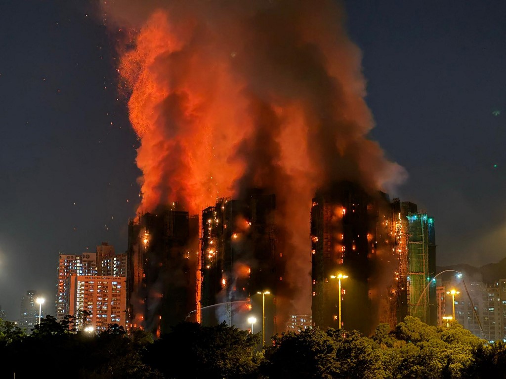 Fire engulfs Hong Kong residential building killing at least 14 people, trapping others