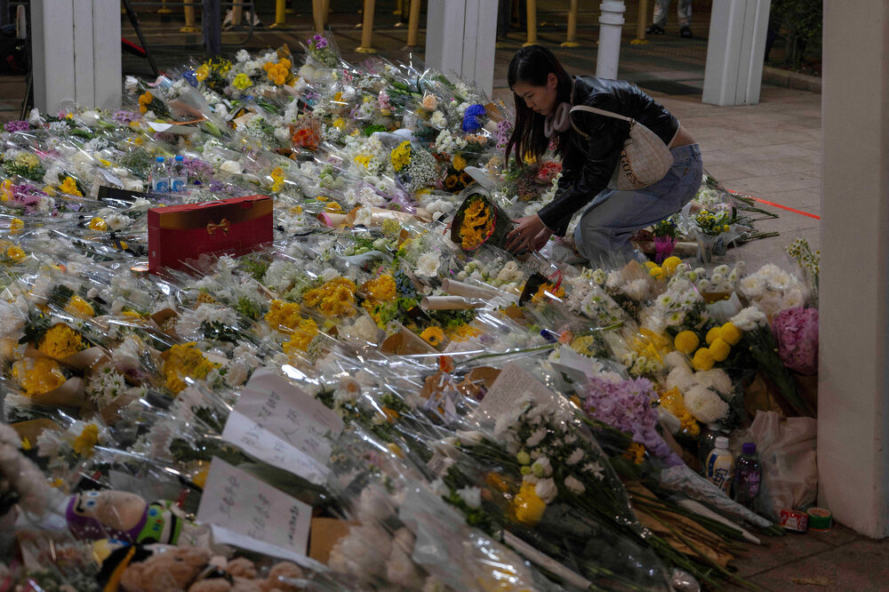 Mourners flock to site of deadly Hong Kong blaze as Beijing warns against protests