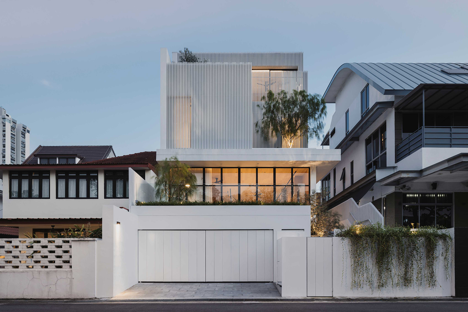 Behind the mysterious white facade of this Singapore house lies a warm, light-filled home