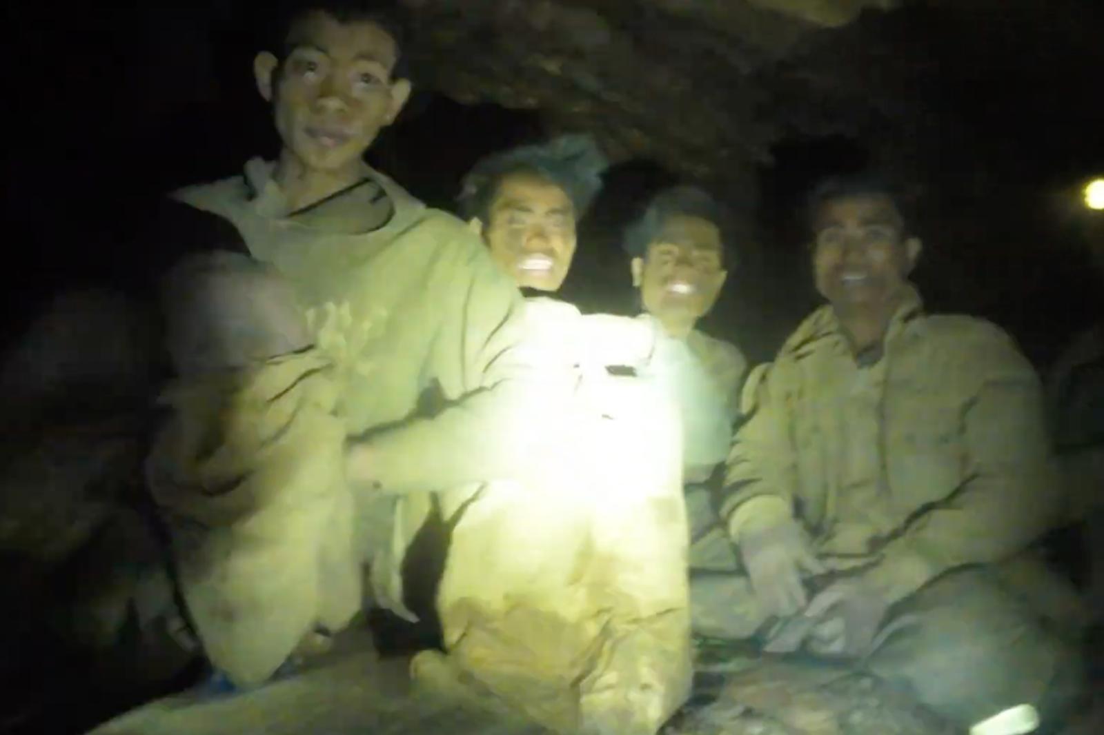 Rescuers evacuate the first of 5 villagers found trapped in a cave in Laos; 2 still missing