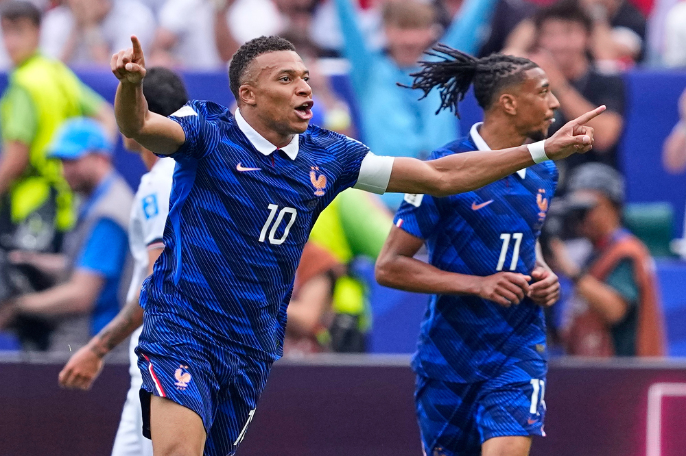 Mbappe double sends France into World Cup knockout rounds after weather delay
