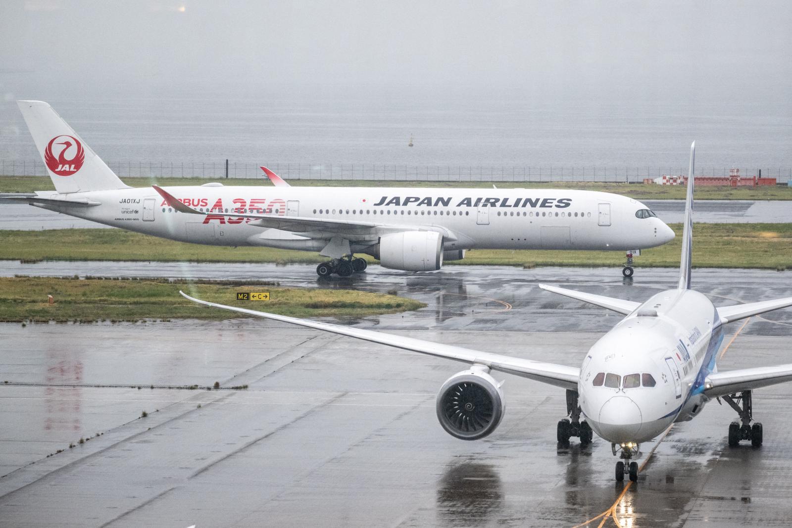 Japan cancels 120 flights as twin storms approach