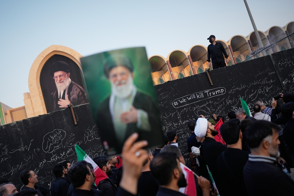 Three sons of Iran's slain leader appear at funeral, not his successor