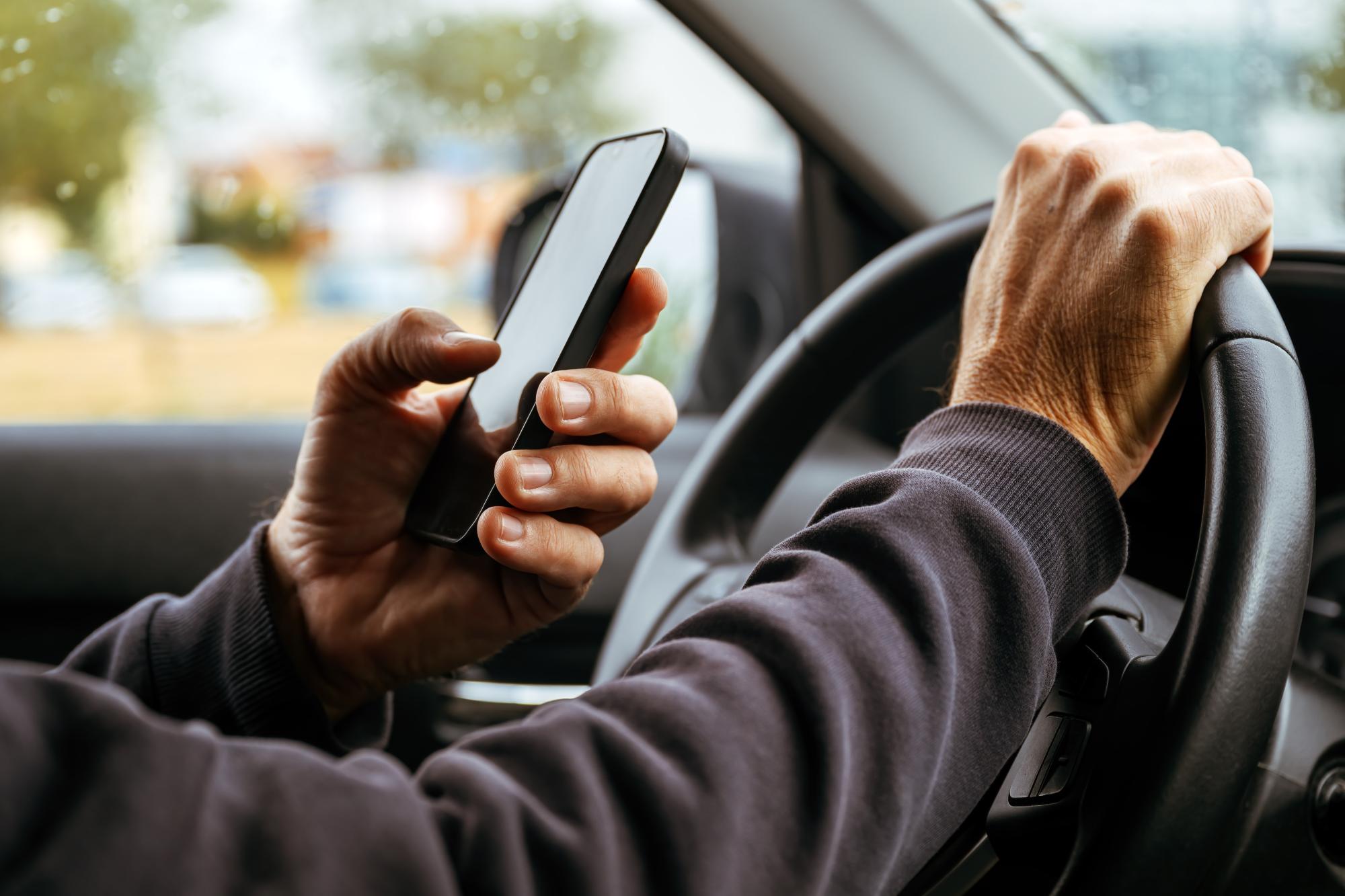 MPs raise concerns over mounted devices, private-hire drivers as law passed to criminalise holding phones while driving