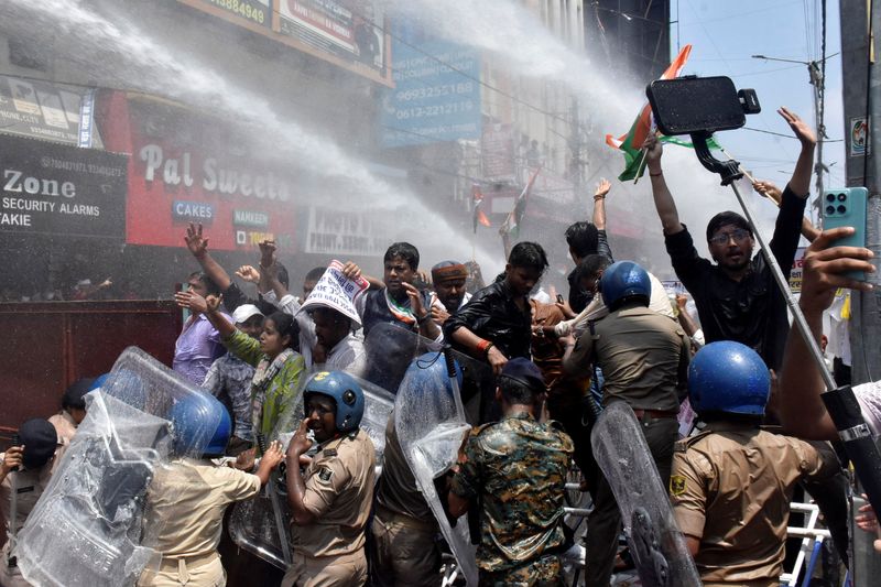 Indian police use water cannon at new protest over test paper leaks