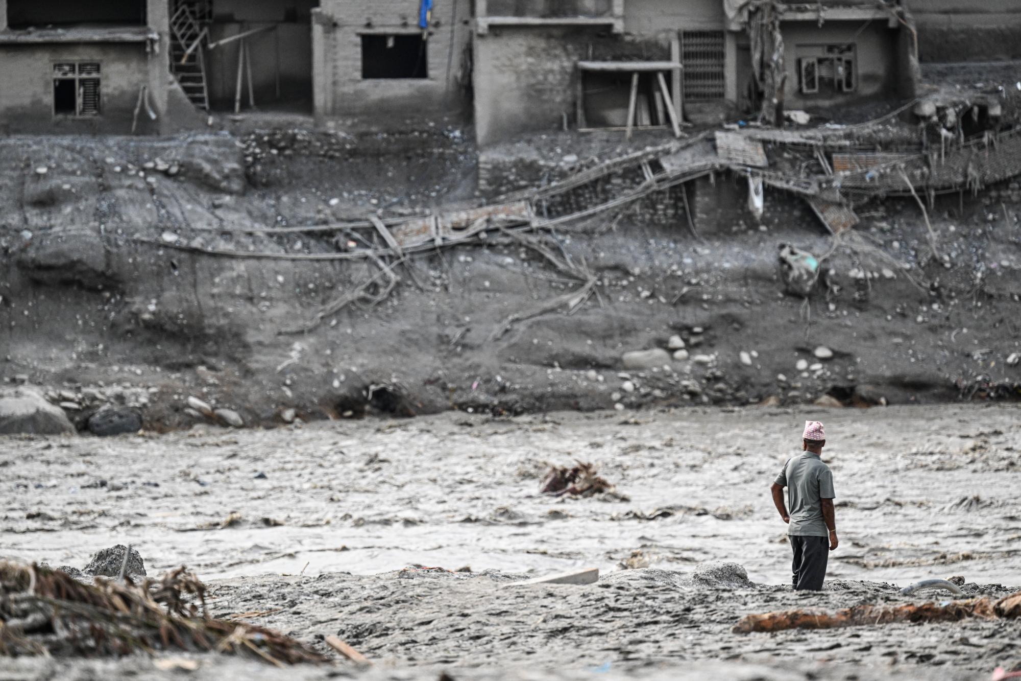 Nepal’s riverside communities cling to hope with loved ones missing after deadly flood